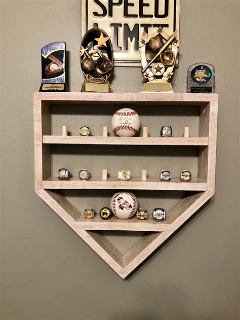Baseball Ring and Ball Holder Dimensions ARO 18x18x4 As pictured it holds 55 Championship Baseball Rings (Items in display case are not included. . Baseball and ring display